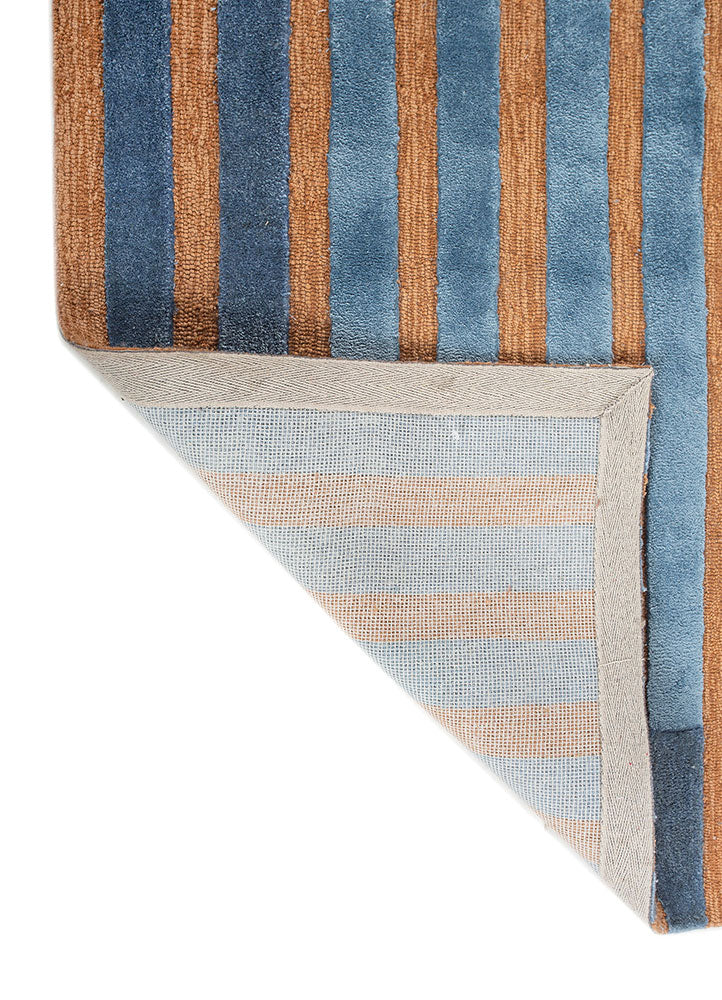 Back corner view of Blue Terra Stripe hand tufted wool rug showing sturdy backing clean edges and quality craftsmanship.