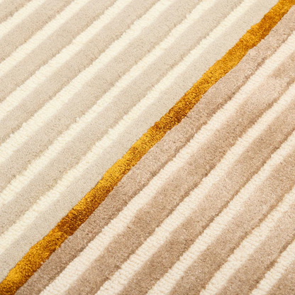 Close up pattern detail of Aurel Gold Line Rug hand tufted wool rug with fine linear texture.