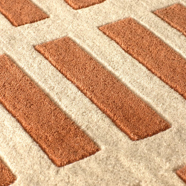 Close up texture of Gridline Terra Wool Rug hand tufted wool rug showing raised grid lines.