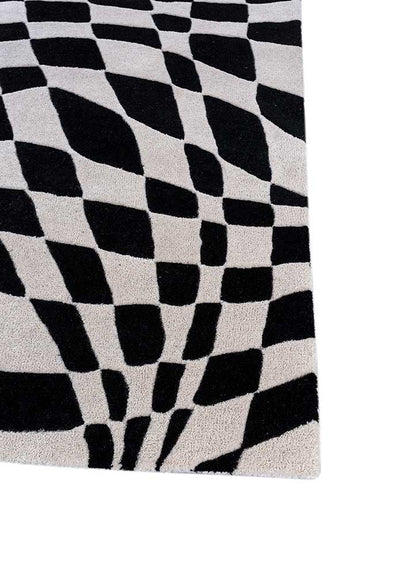 Corner close-up of Abstract Optical hand tufted wool rug showing edge binding.