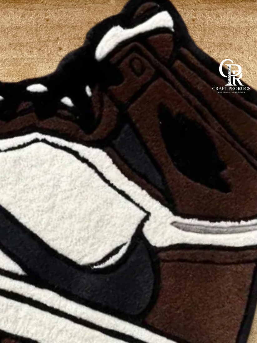 Side angle view of Air Jordan Brown Hand-Tufted Rug showing detailed sneaker shape and clean handcrafted edges.