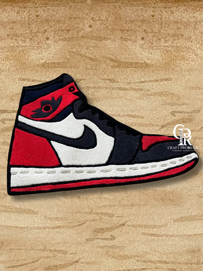 Side angle view of Air Jordan Red Hand-Tufted Rug displaying sharp sneaker edges and detailed sole design.