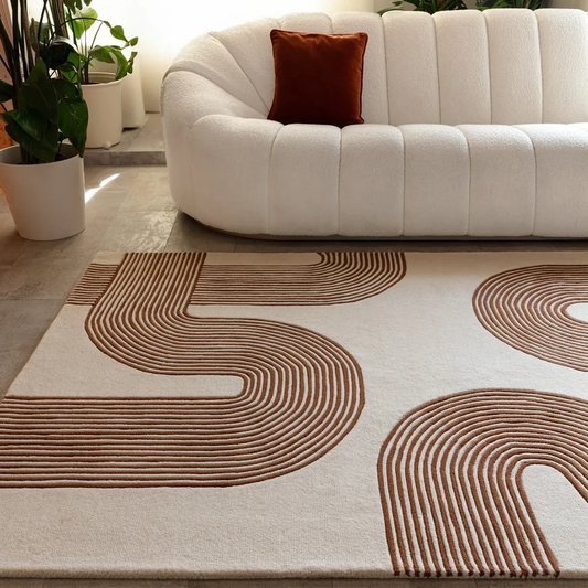 Amity Terra Linear hand tufted wool rug styled in a modern living space with flowing linear curves in warm terra tones.