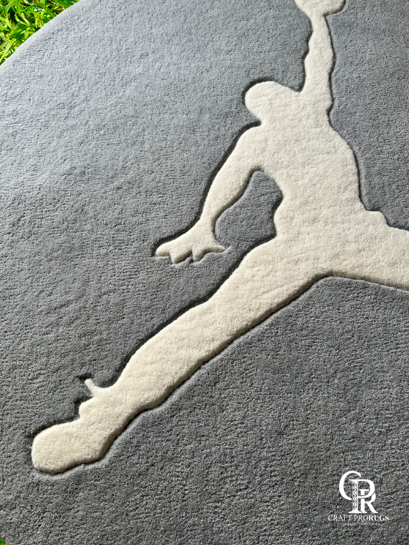 Close-up view of athlete silhouette round hand-tufted rug showing plush texture, clean edges, and premium craftsmanship