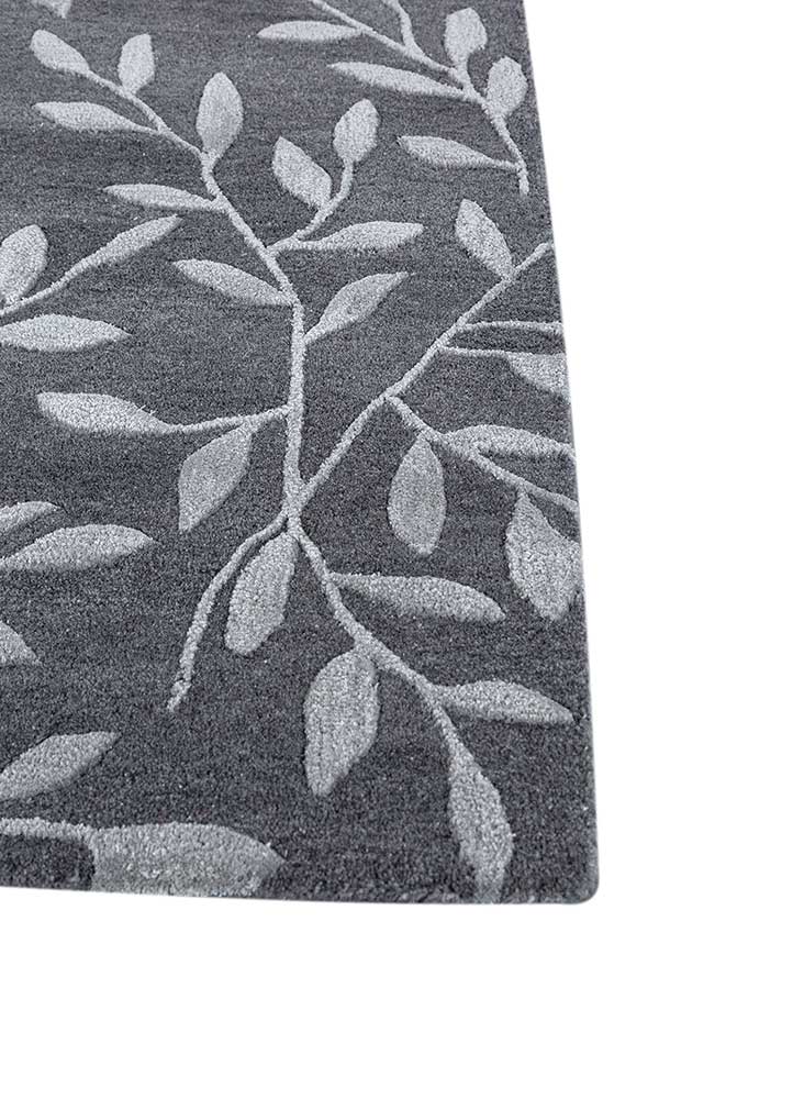 Corner close-up of Botanical Vine hand tufted wool rug showing edge binding and pile depth