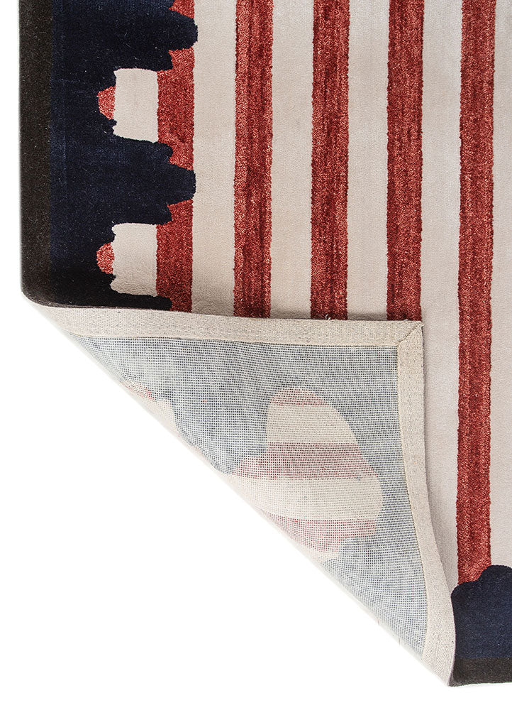 Back corner view of Crimson Rhythm Striped hand tufted wool rug showing sturdy backing neat finishing and craftsmanship.