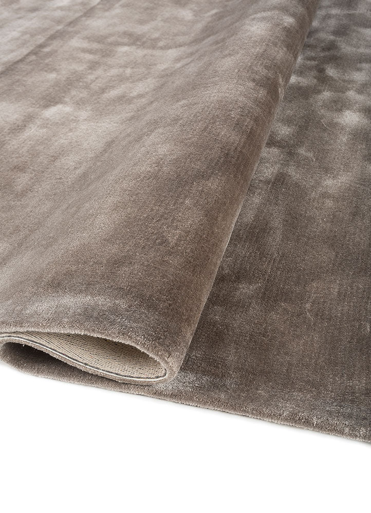 Rolled corner of Earthy Tone Taupe Hand-Tufted Wool Rug highlighting plush wool pile and craftsmanship.