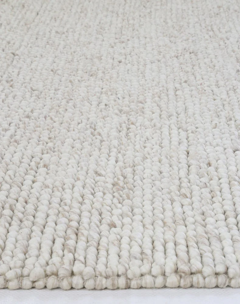 Close-up of flatweave Nirvana Chalk Pebbles rug showing detailed woven texture and subtle chalk pebble design