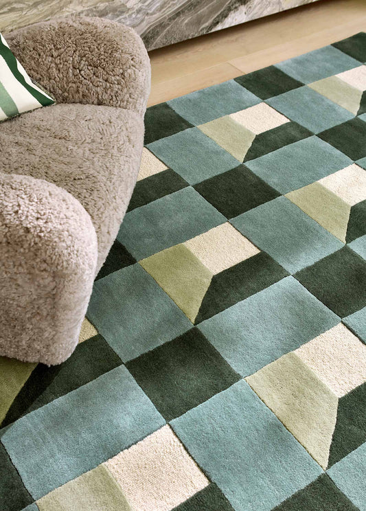 harlequin geometric rug in shades of green cream and teal showing full rectangular pattern.
