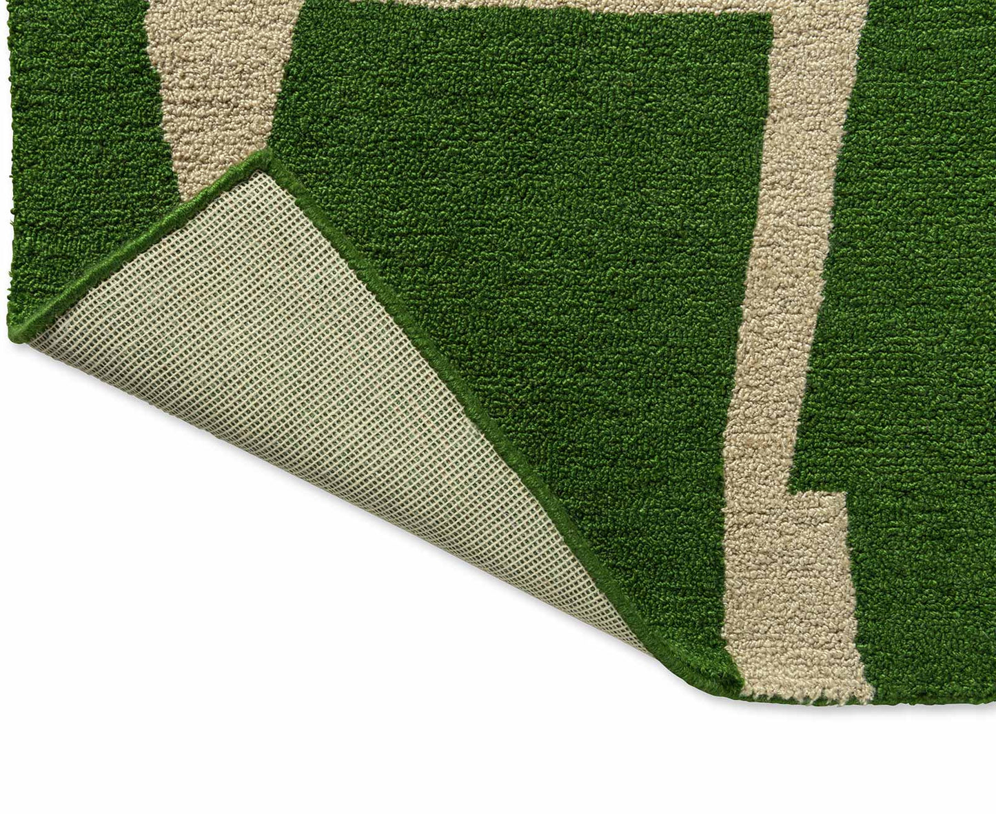 Back fold view of Moqui Green hand tufted wool rug showing flexibility and durable hand tufted wool backing.