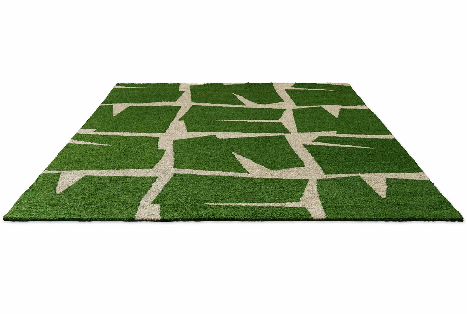 Moqui Green hand tufted wool rug showing full geometric pattern with sharp ivory lines over deep green background.