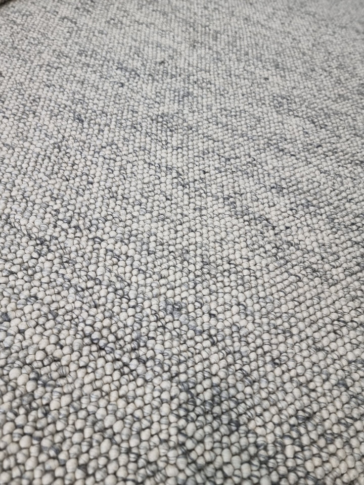 Detailed surface of pebble texture flatweave pure wool rug with natural wool texture