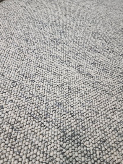 Detailed surface of pebble texture flatweave pure wool rug with natural wool texture