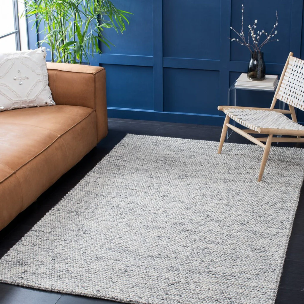 Pebble texture flatweave pure wool rug styled in a modern living room interior 