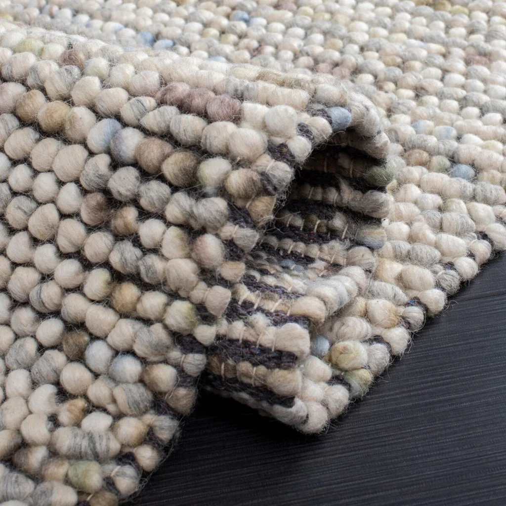Close-up of Pebbles Multi Ivory flatweave rug showing looped wool and cotton texture, low-profile hand-woven design