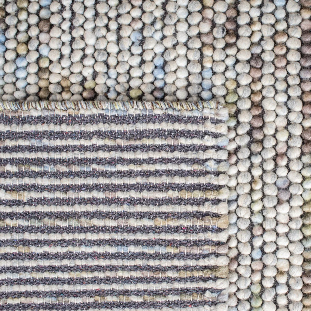 Corner view of Pebbles Multi Ivory flatweave rug highlighting hand-woven wool and cotton loops, durable low-profile rug