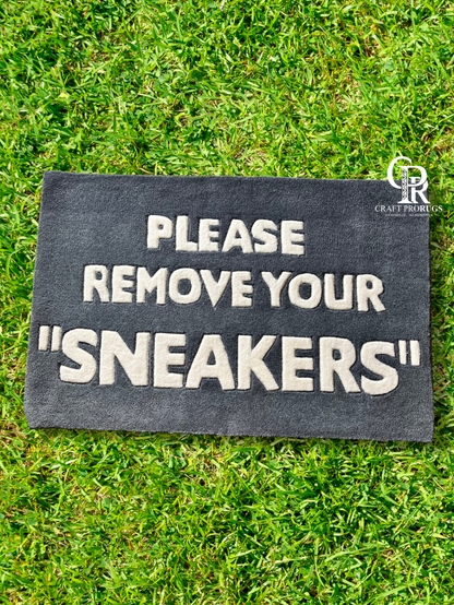 Hand-tufted Remove Sneakers Doormat front view on grass