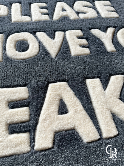 Close-up of hand-tufted text on Remove Sneakers Doormat