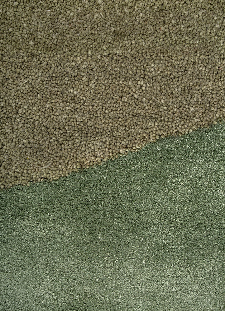 Close up texture of Sage Horizon hand tufted wool rug highlighting dense pile soft touch and subtle green shading.