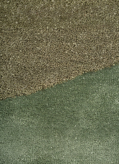 Close up texture of Sage Horizon hand tufted wool rug highlighting dense pile soft touch and subtle green shading.
