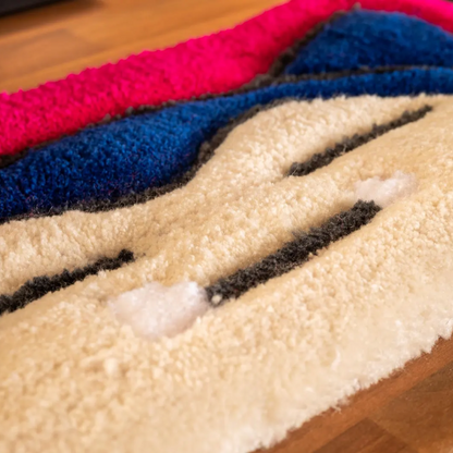 Close-up of hand‑tufted yarn texture on Snorlax keyboard rug showing soft anime design