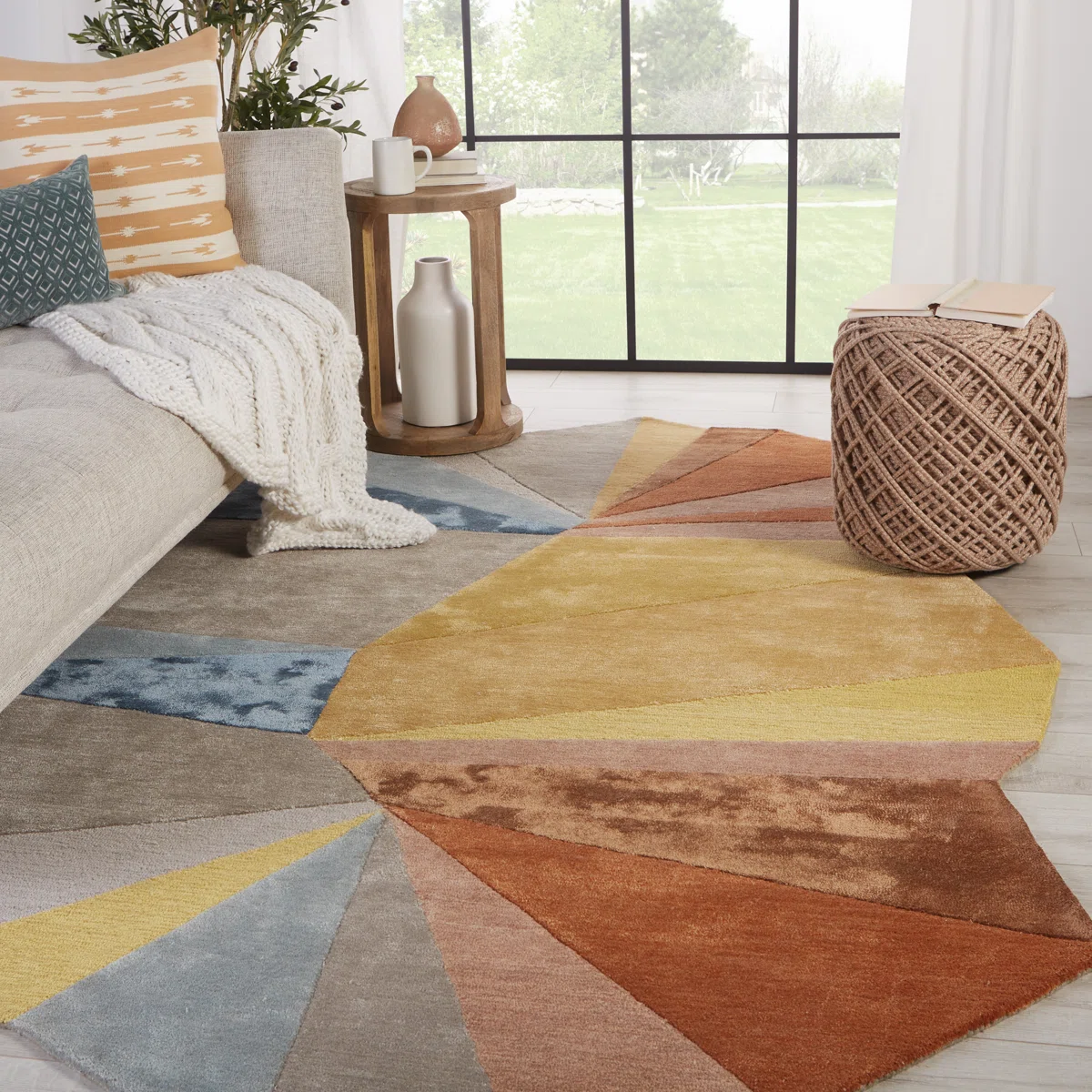 stanford geometric rug placed in bedroom with bed and natural light showcasing modern interior.