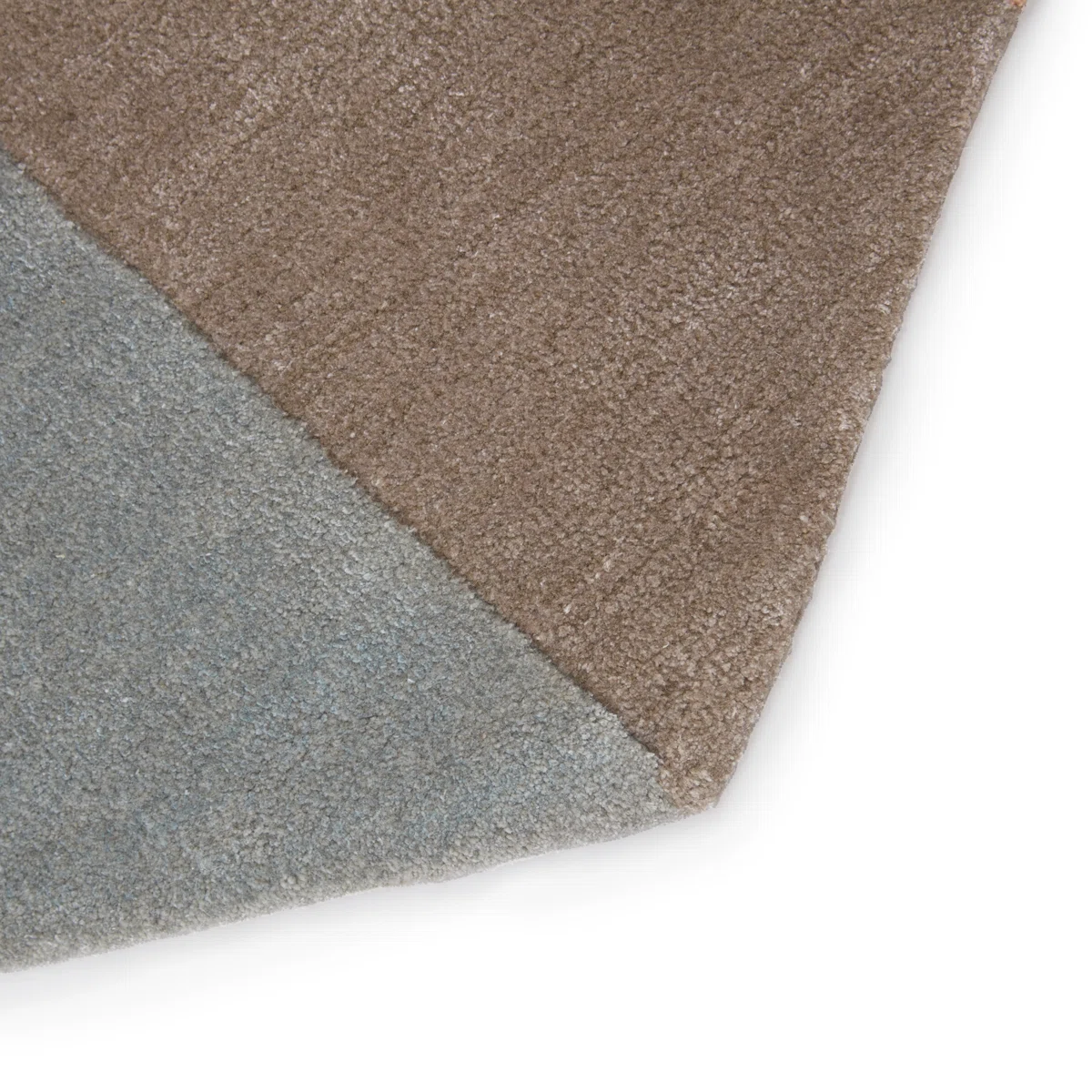 folded stanford geometric rug showing texture and premium hand-tufted wool quality.