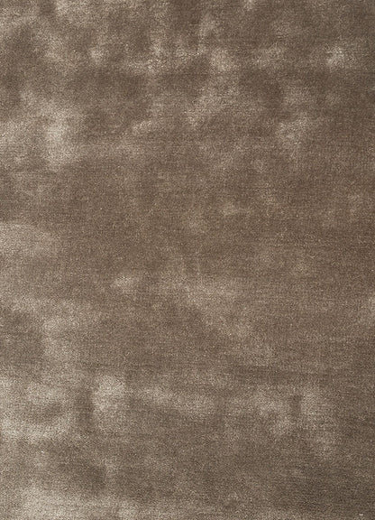 Close view of hand tufted wool rug highlighting smooth surface texture and rich taupe tone.