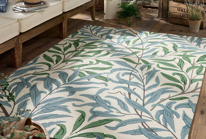 Willow Leafy Arbour hand tufted wool rug placed under seating highlighting botanical leaf pattern and natural color palette.